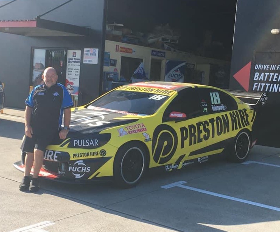 Race car outside Our Town Batteries and Lubricants